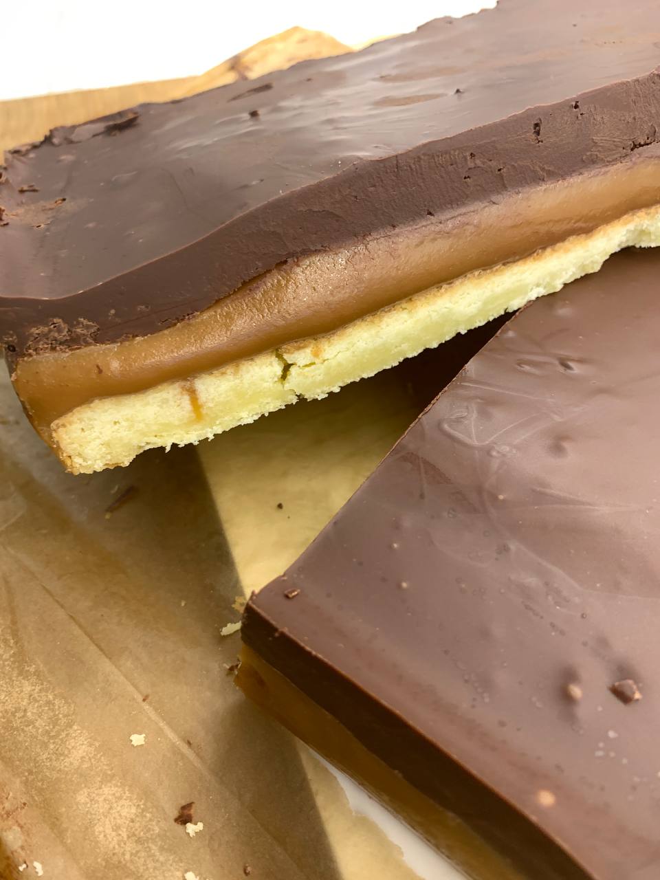 millionaire shortbread with a golden caramel center and velvety chocolate topping.